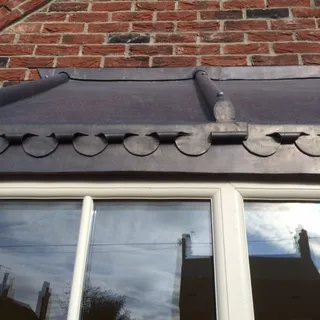 Lead-covered bay window roof with rolls and decorative tiles in Lincoln