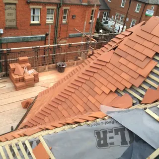 New roof being tiled over breathable membrane and battens – new roofing Lincoln