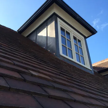 Lead-clad dormer on a tiled roof repaired by local roofers in Lincoln