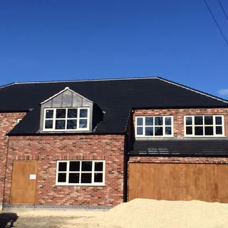 New build house roofed by Allen Roofing, one of the established roofing companies in Lincoln