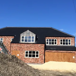 Finished slate-effect roof with lead-clad dormer on a new build – roofing Lincoln