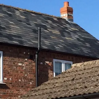 Slate roof on a brick cottage after slate roof repairs in Lincoln